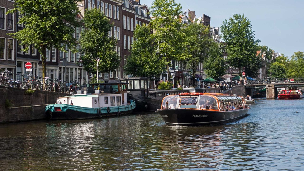 Boat cruising through the canals of Amsterdam