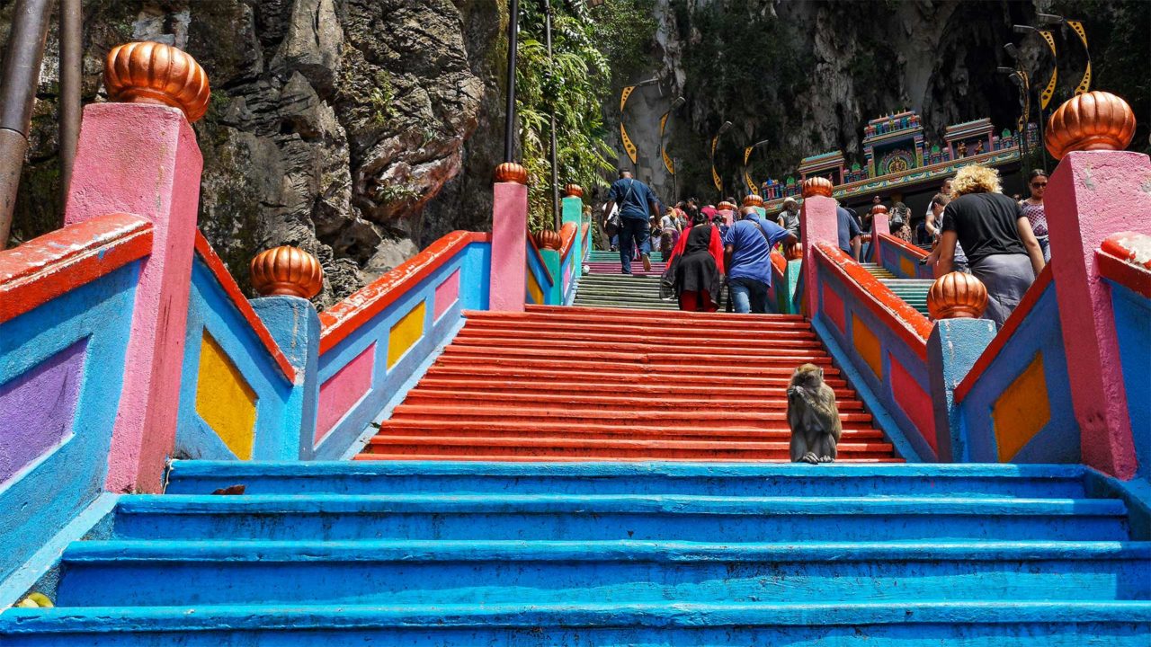 The stairs to the Batu Caves with a monkey