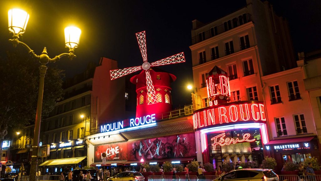 The illuminated Moulin Rouge theater at night in Paris