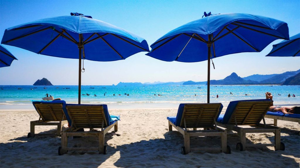 Sunbeds and turquoise water at Selong Belanak Beach near Kuta