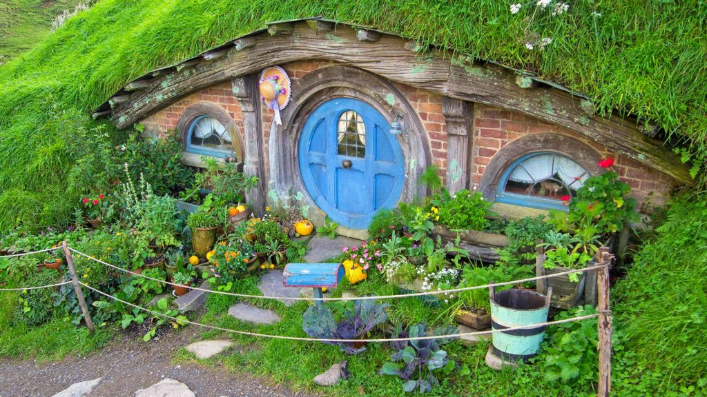 Small Hobbit house with a blue door in Hobbiton, Matamata