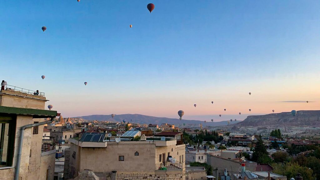 Goreme in Cappadocia with hot air balloons in the sky